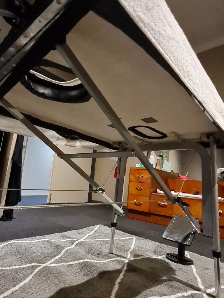Underneath a milking massage table with a sneaky mirror underneath