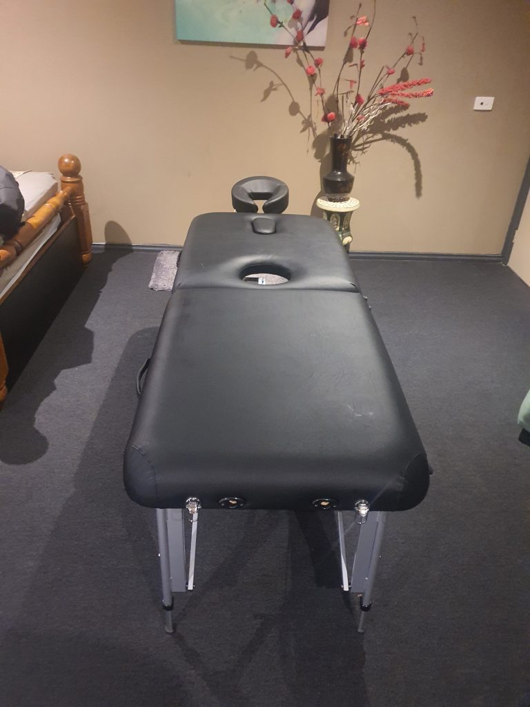 A black vinyl custom reupholstered firm'n' fold milking table for erotic massage